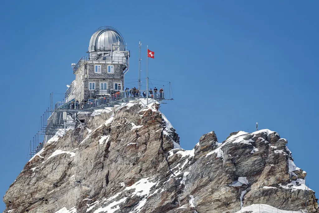 The Sphinx Observatory on the rock spur above the Jungfraujoch against a blue sky